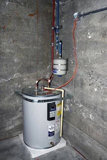 Electric tank water heater connected to residential plumbing lines