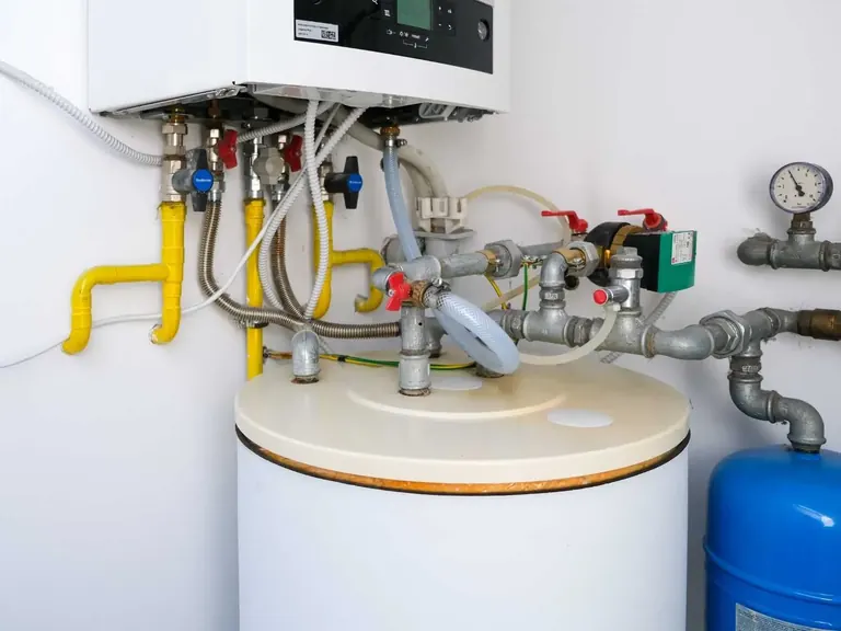 Water heater piping and valves being checked during plumbing repair service